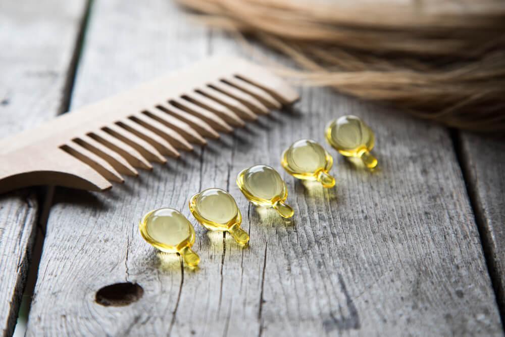 Hair supplements on table next to comb