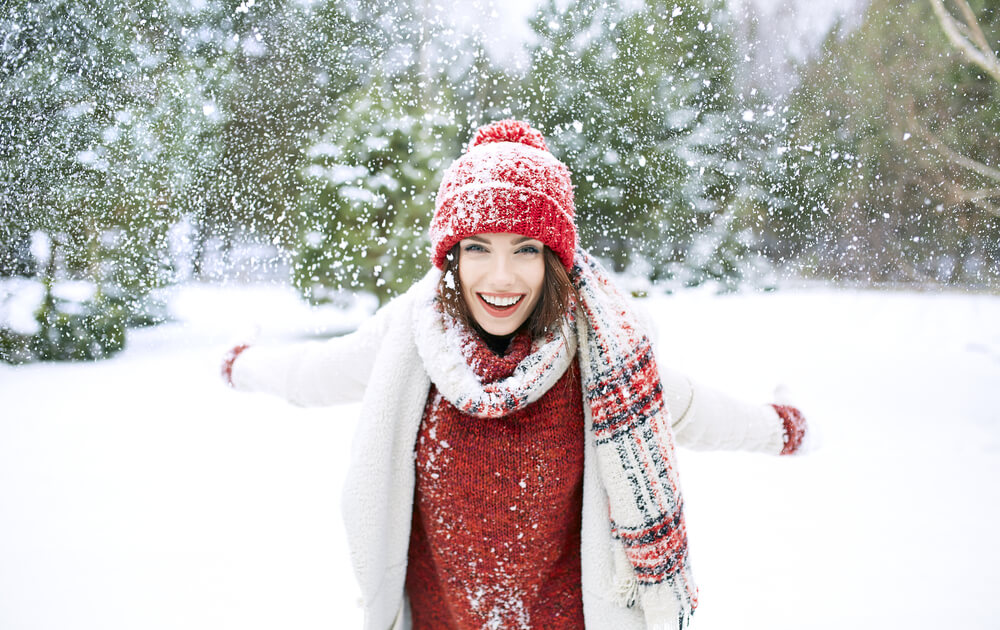 Woman in snow with hat