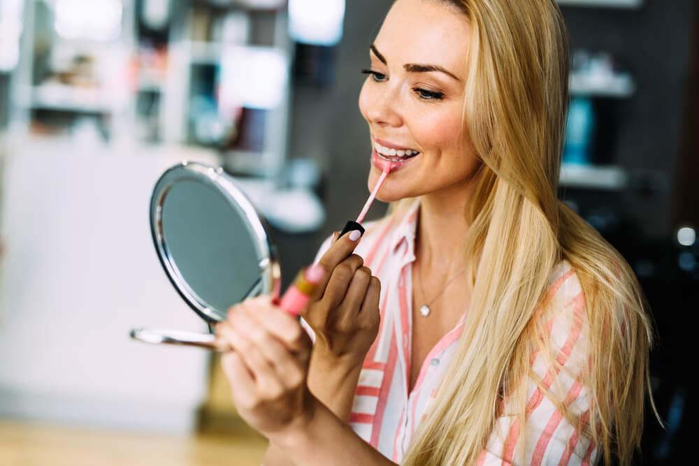 woman applying makeup at home
