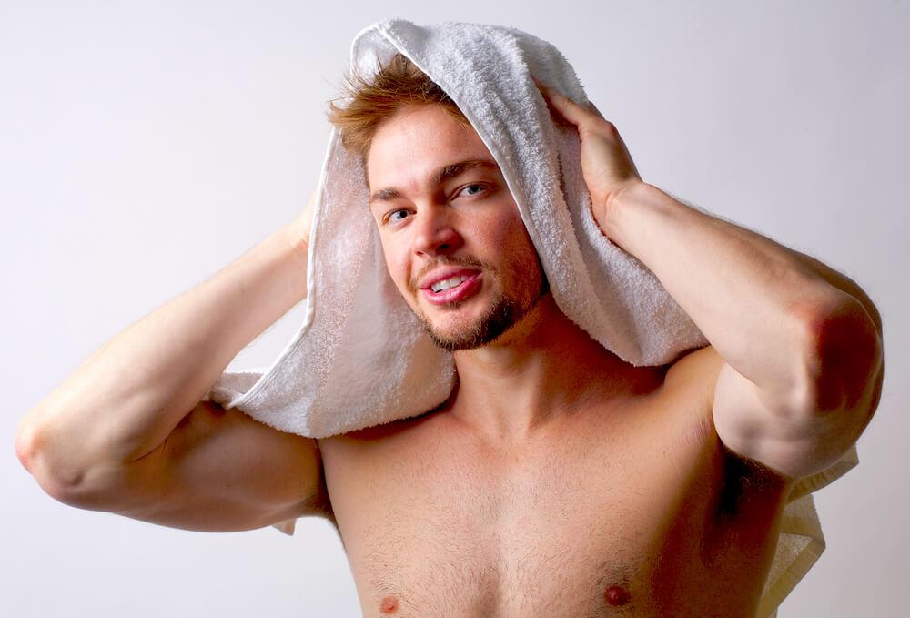 man toweling hair dry