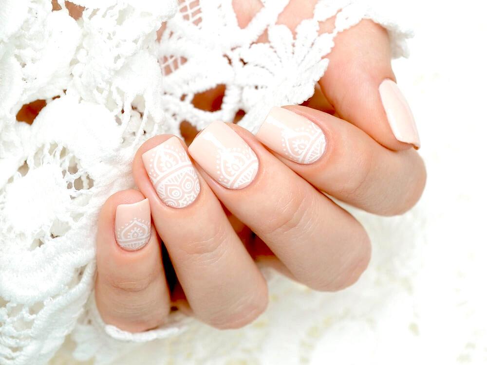 mandala nail design in nude and white