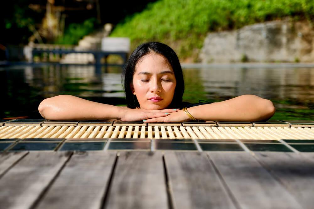 woman relaxing in outdoor pool