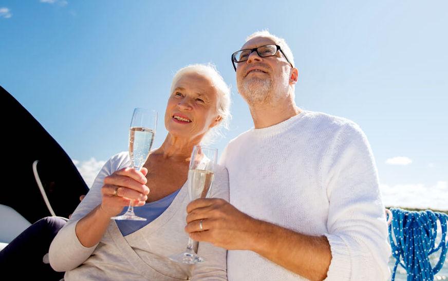 Senior couple enjoying champagne on a cruise