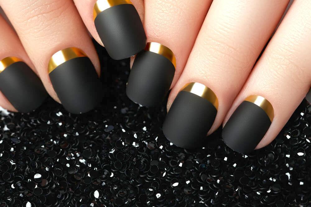 Matte black and gold nail art design