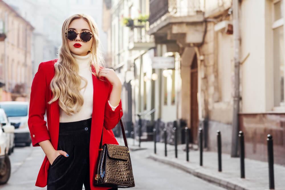 Fashionable woman in red coat and white turtleneck sweater