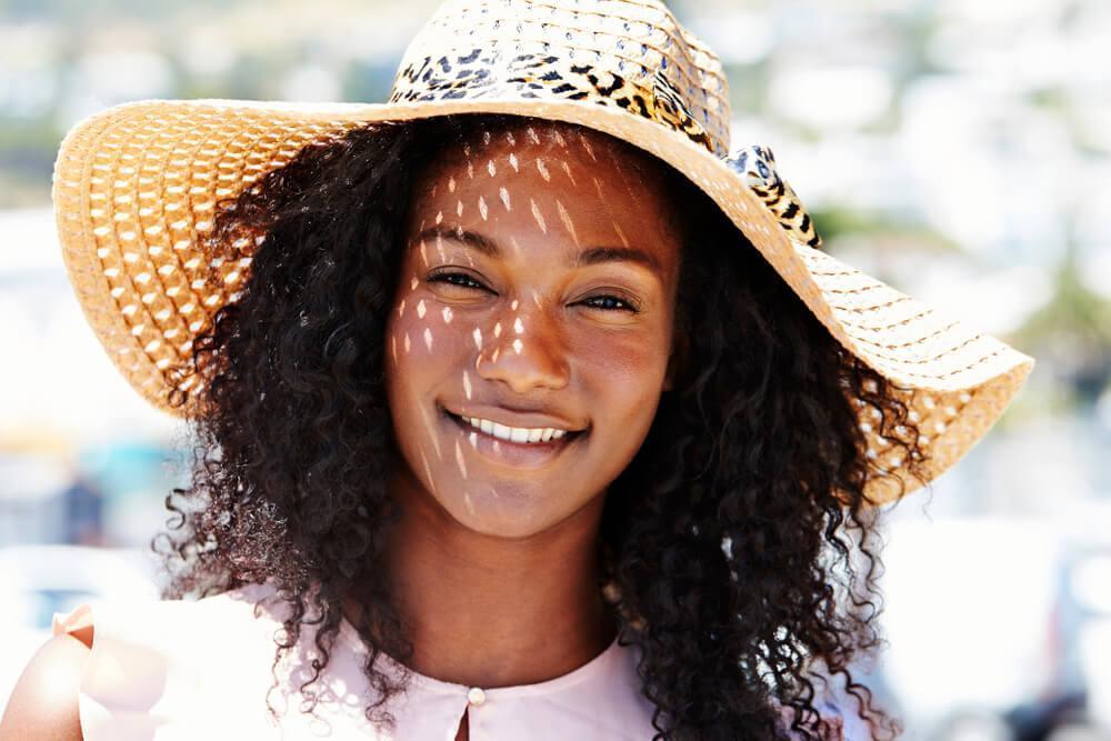 Smiling woman with straw hat 