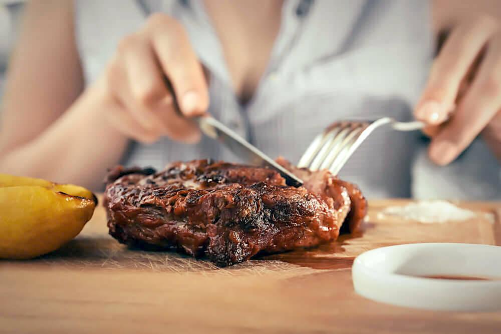 Cutting into a thick slice of cooked beef