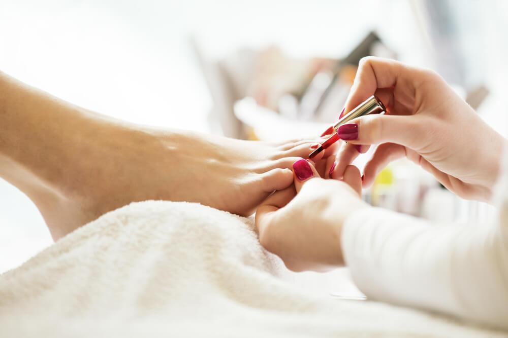 Woman having toenails painted