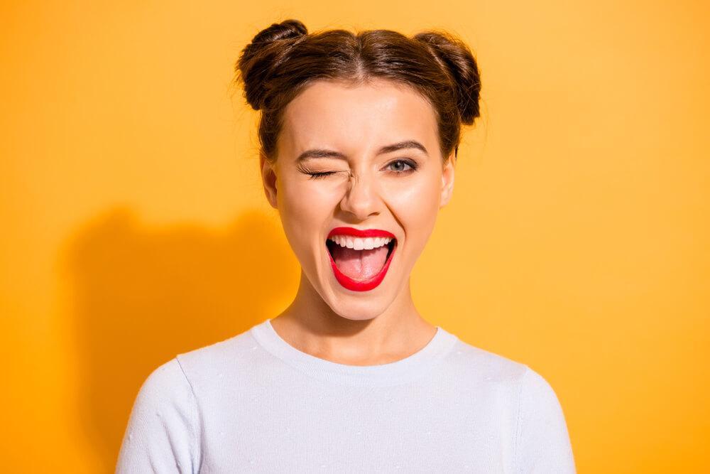 Woman with red lipstick winking