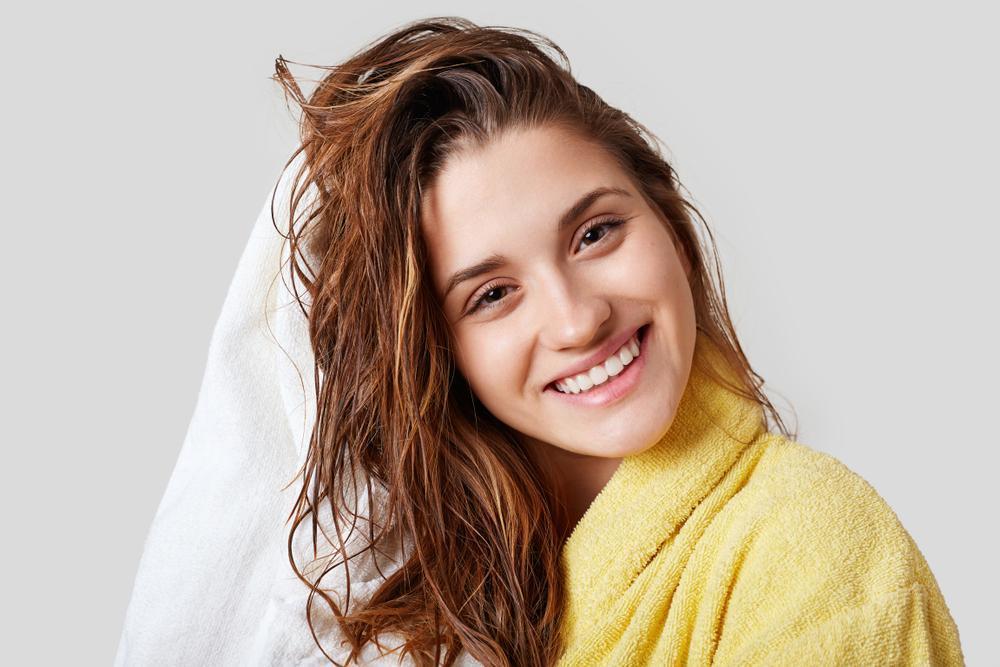 Woman drying hair with towel