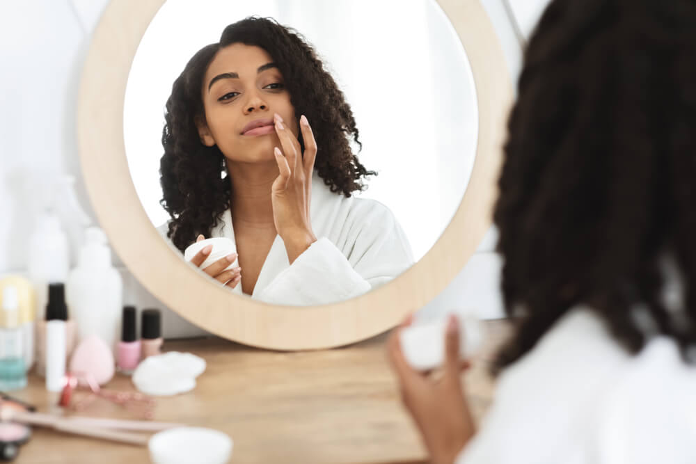 Woman applying face cream