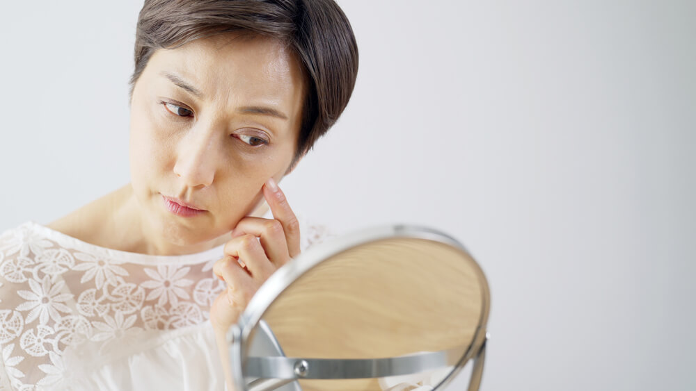 woman looking at mirror