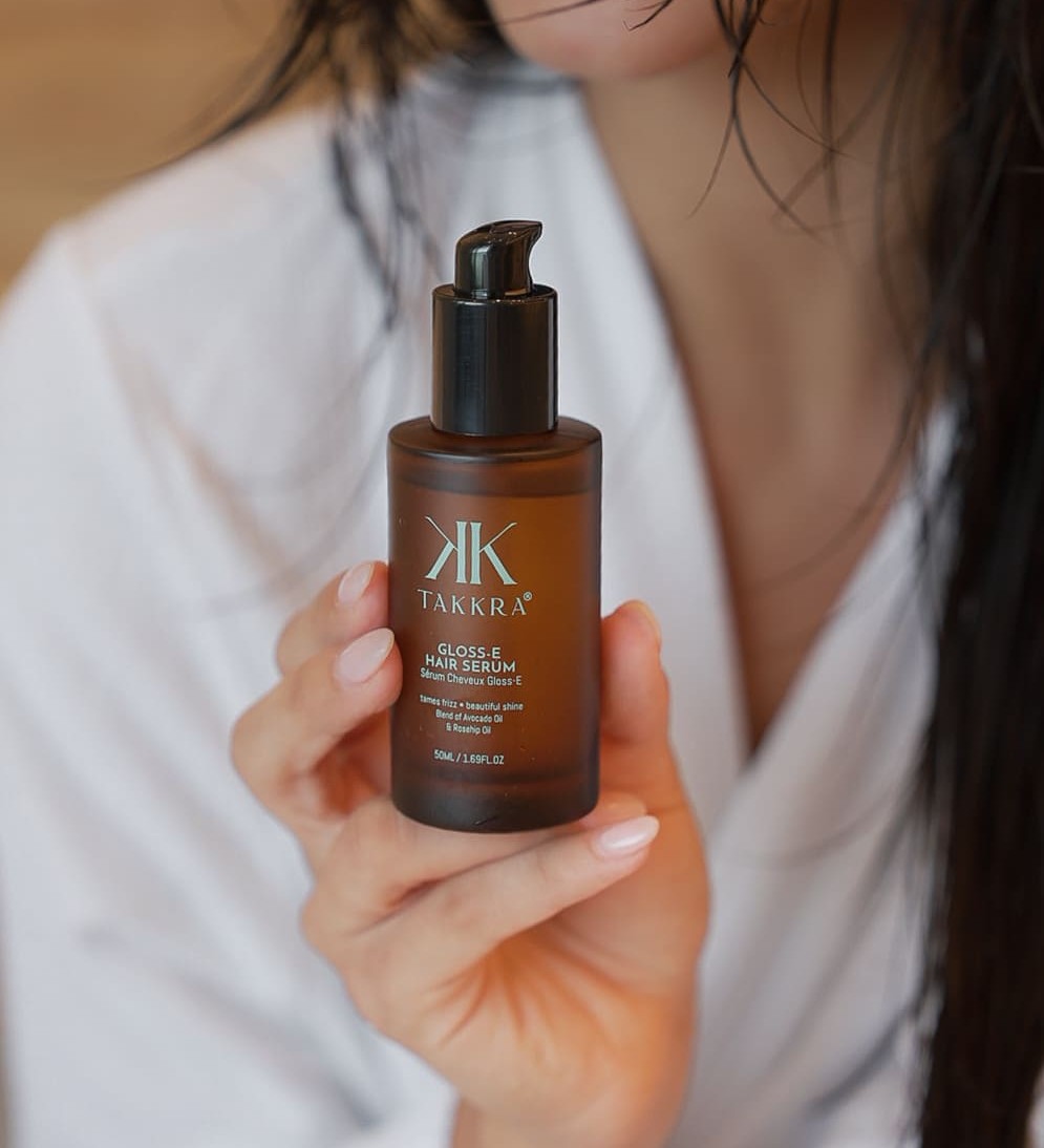Woman holding Takkra hair serum