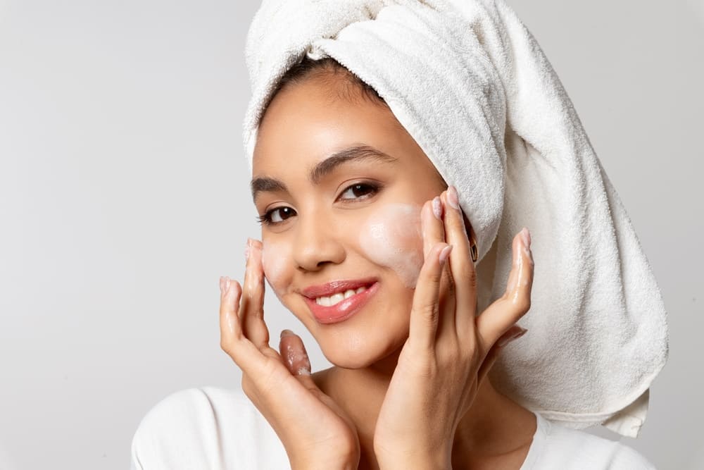 Woman using luxury cleanser on face