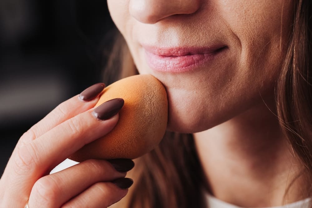 Woman applying foundation