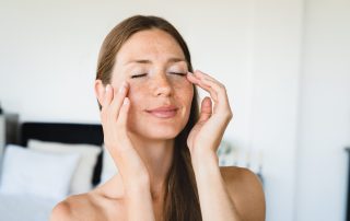 Woman touching face to see how resilient her skin feels
