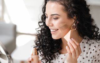 Woman applying makeup to smile lines